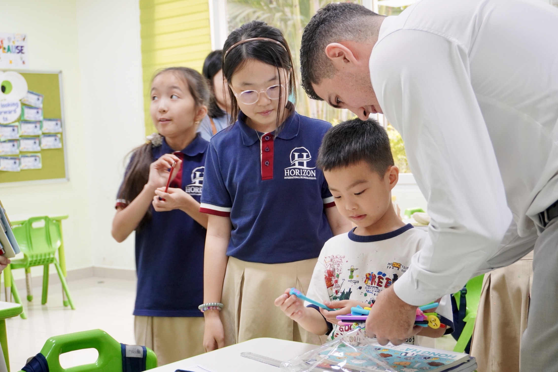 A Horizon teacher guiding children through a hands-on classroom activity