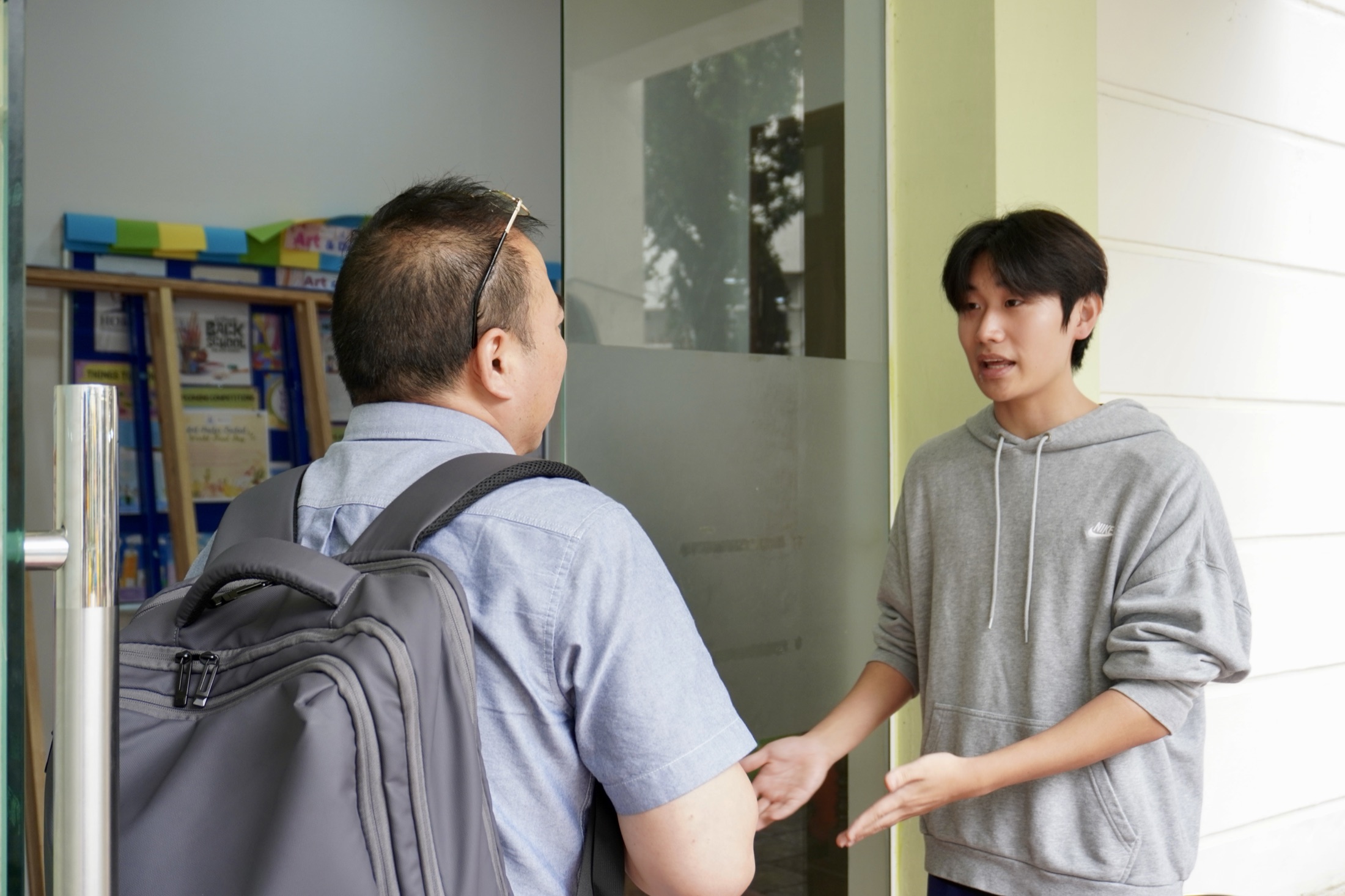 A Horizon student welcoming a visitor at the classroom door